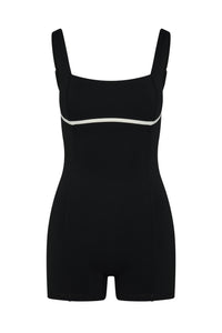 Front view of Zion Romper in Black/Ivory showcasing square neckline and contrast ivory underbust piping on white background