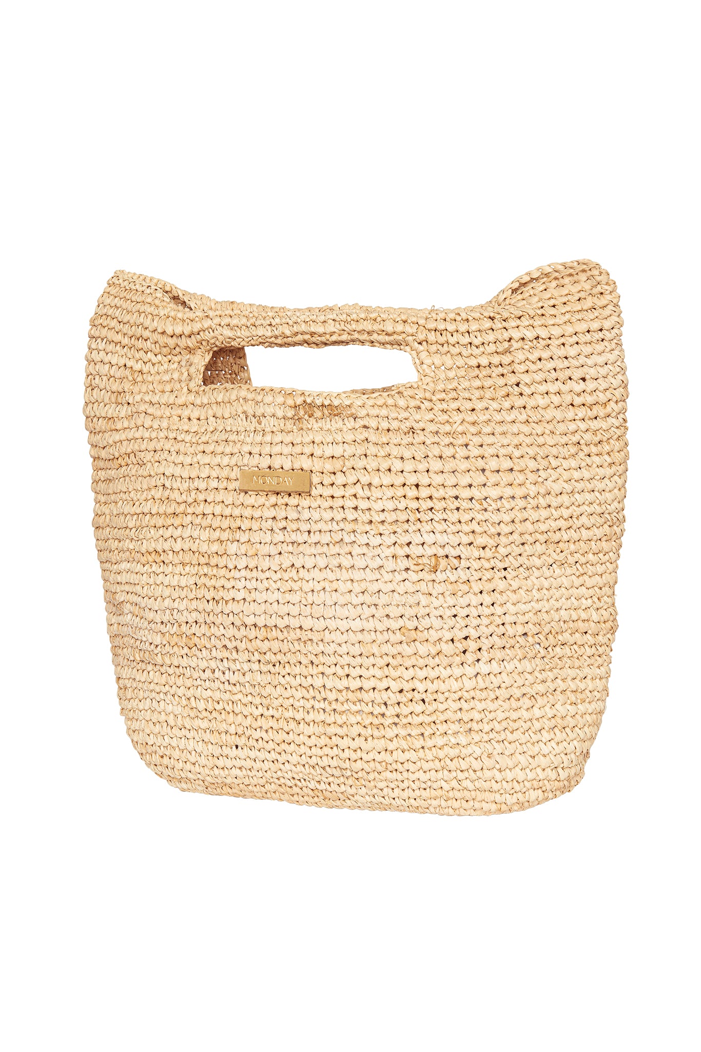 Woven straw tote bag with built-in top handle and small rectangular metal tag reading MONDAY